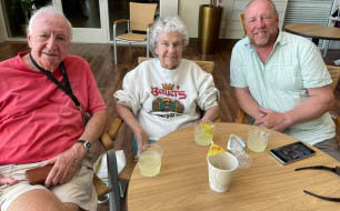 Janet with her husband and son enjoying happy hour and music