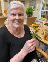 memory care resident arranging flowers