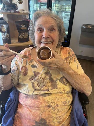 memory care resident smiling enjoying ice cream