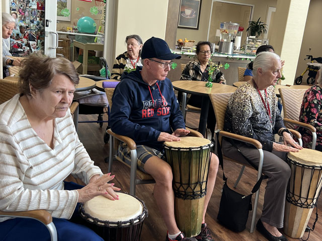 memory care residents drum circle fun