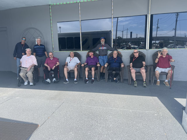 memory care residents sitting outside the Varsity Club