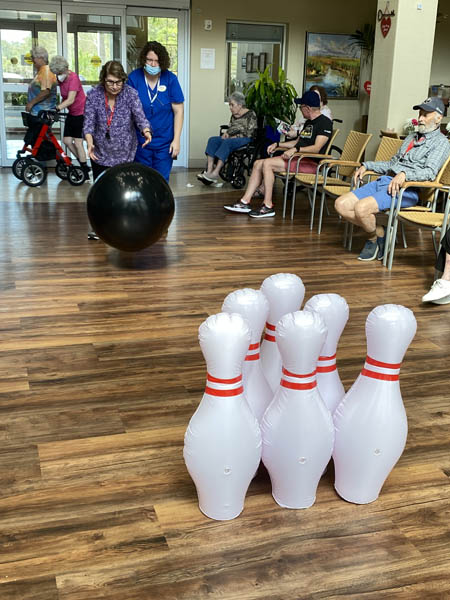 memory care resident having fun bowling
