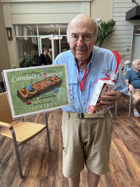 memory care resident Bob with his cornhole prize