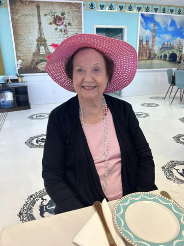 memory care resident Dot wearing a pink hat