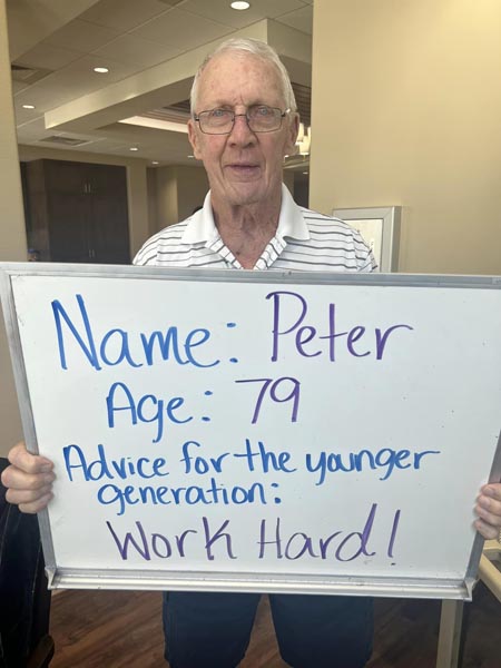 memory care resident peter with sign