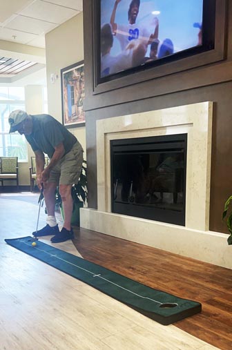 memory care resident practicing putt putt