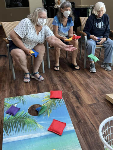 memory care residents playing cornhole