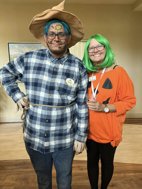 memory care residens dressed up as scarecrow and pumpkin
