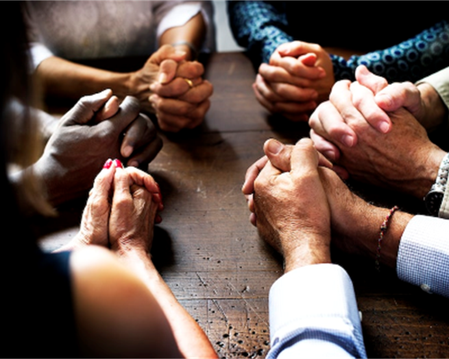 coming together in prayer at Aravilla Clearwater Memory Care