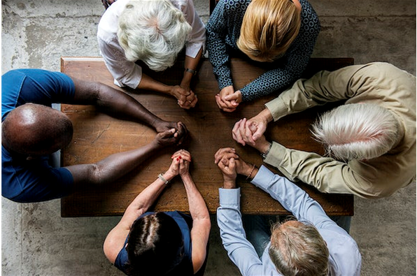 memory care residents coming together in prayer