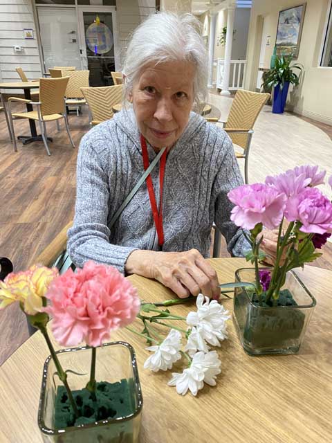 memory care residents making flower arrangements