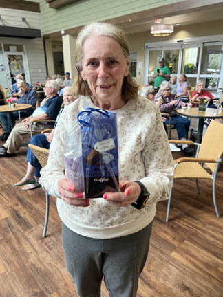 happy memory care resident with her prize