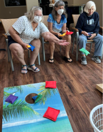 memory care residents tossing bean bags