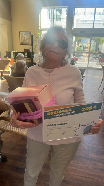 senior resident show her prize at Aravilla Clearwater