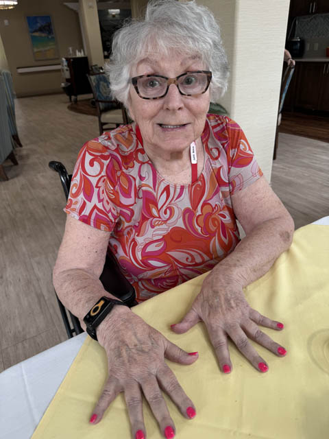 memory care resident showing off her nails
