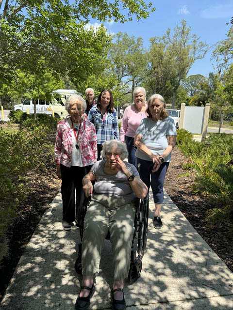 memory care residents walking on a path