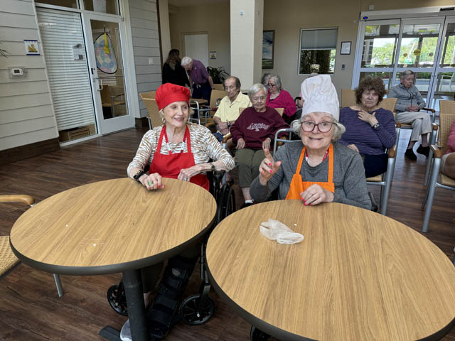 memory care residents wearing chef hats