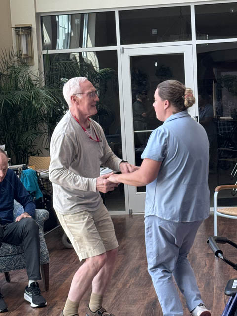 memory care resident dancing happily