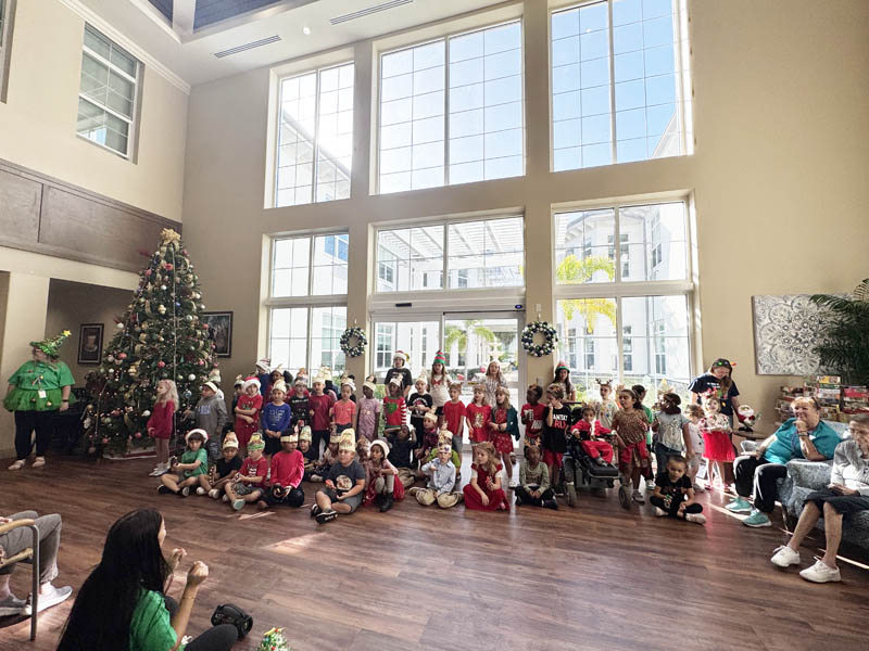 Santas helpers singing at Aravilla Clearwater memory care