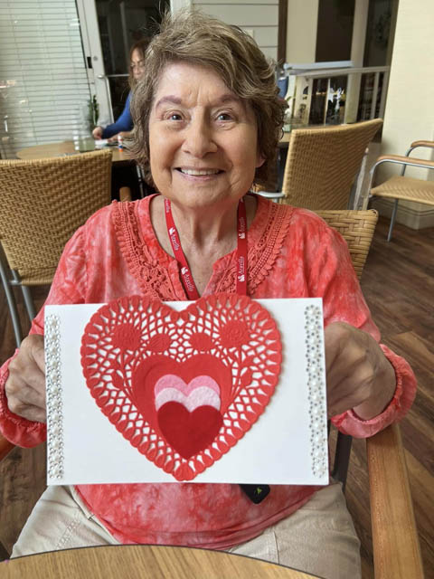 memory care residents making Valentines cards