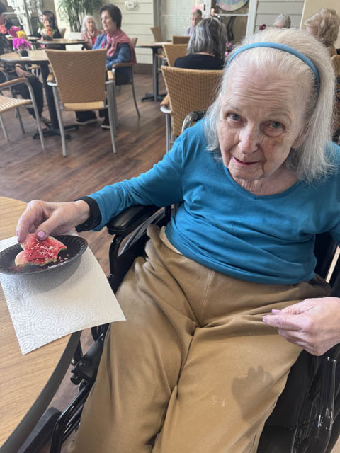 memory care resident enjoying Valentines Day cookie