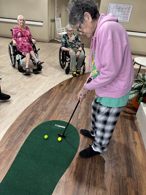 memory care resident playing putt putt golf