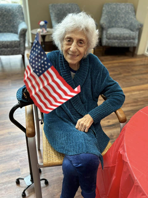memory care resident holding flag memory care resident holding flag